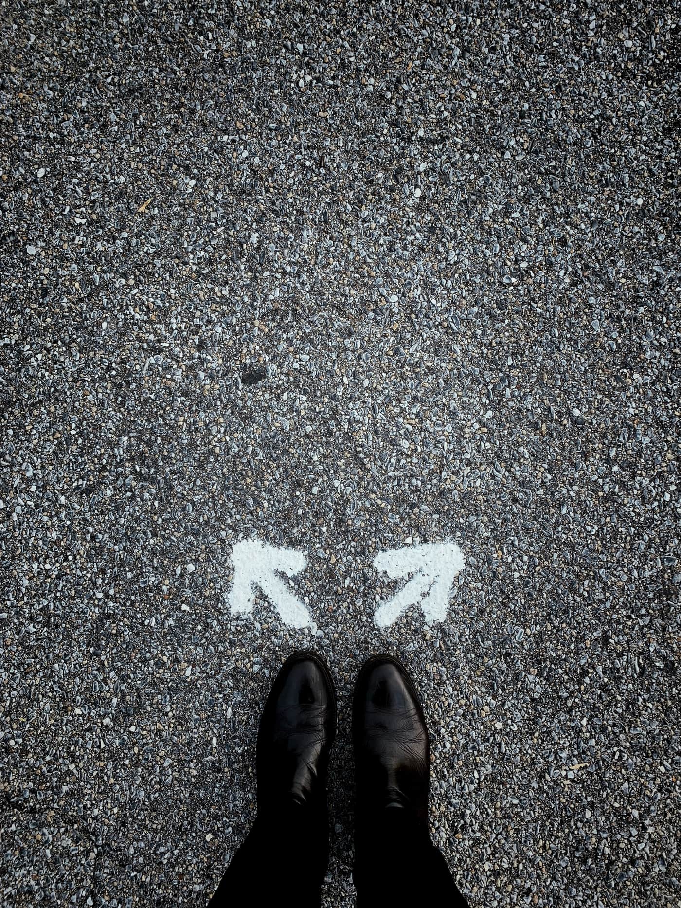 Two painted arrows pointing in different directions
