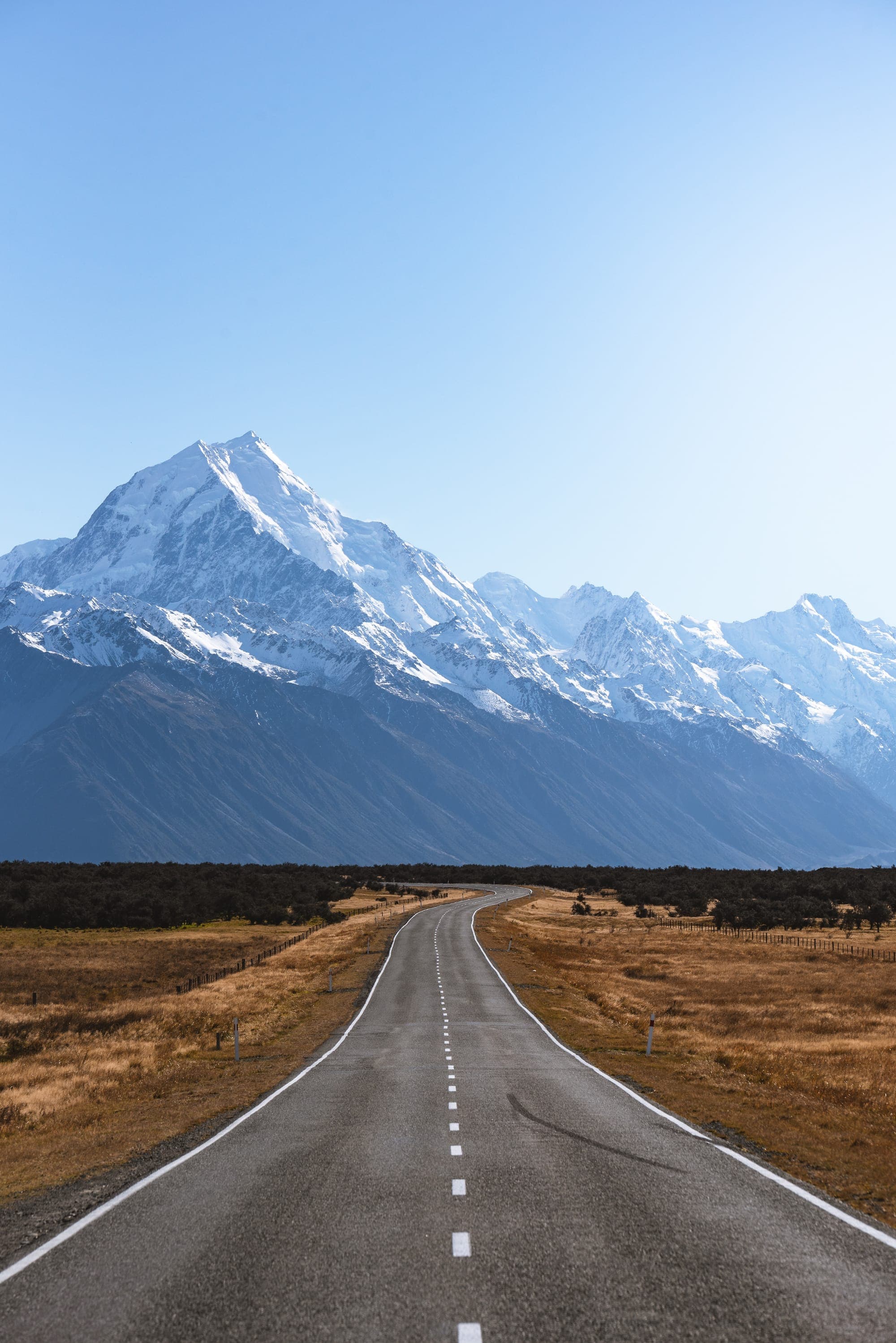 A long open road leading toward a distant mountain